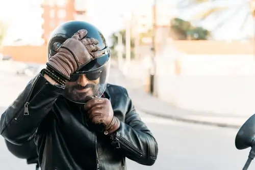 Motorcycle Rider Adjusting Helmet Before Ride Imgae